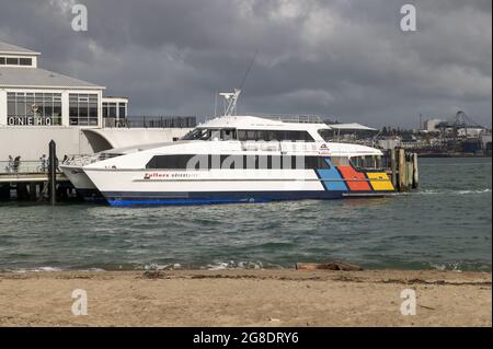 AUCKLAND, NEW ZEALAND - Jun 28, 2021: The Fullers Adventurer catamaran commuter ferry at the wharf in Devonport, Auckland, New Zealand Stock Photo