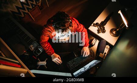 Man Working Late at Night Distracted on His Phone, Stress Anxiety Exhaustion Stock Photo