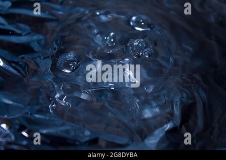 falling drops of water formed an interesting round funny smiley face on the water surface Stock Photo