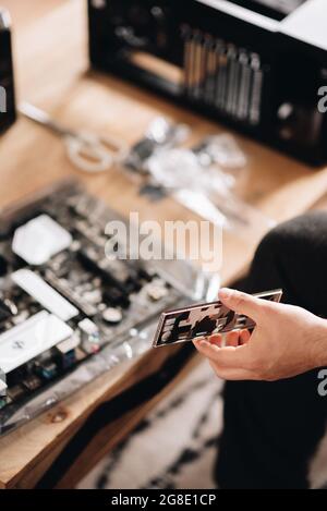 Vertical shot of a hand of the technician examining the pc detail Stock Photo