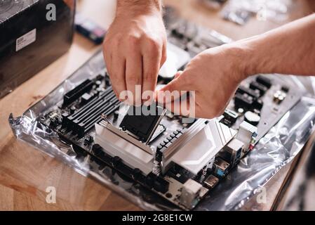 Closeup shot of hands of a technician repairing the pc Stock Photo