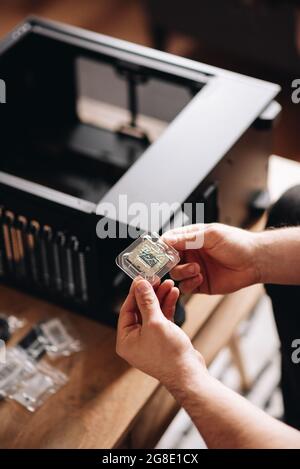 Vertical shot of a man's hands holding a CPU Stock Photo