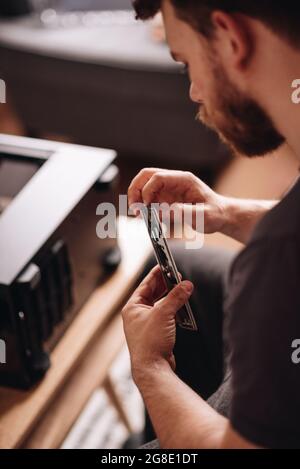 Vertical shot of a caucasian technician examining the pc details Stock Photo