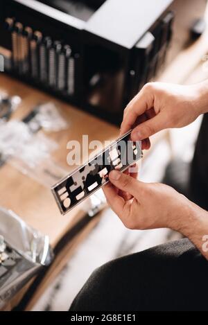 Vertical shot of hands of the technician examining the pc details Stock Photo