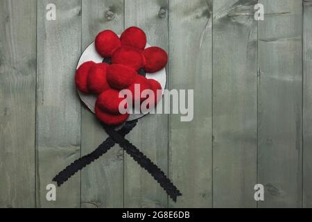Original Black Forest Bollen hat in front of green wooden wall, Germany Stock Photo