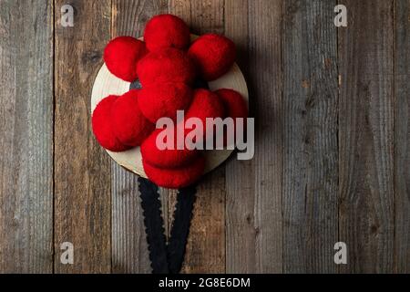 Original Black Forest Bollen hat in front of rustic wooden wall, Germany Stock Photo