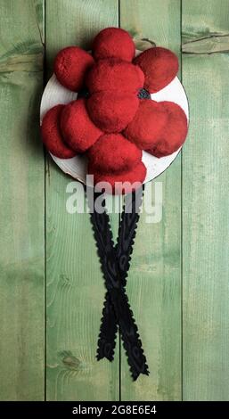 Original Black Forest Bollen hat in front of green wooden wall, Germany Stock Photo