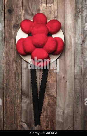 Original Black Forest Bollen hat in front of rustic wooden wall, Germany Stock Photo