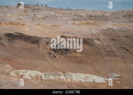 Tourists on mountainside at volcano Namafjall, high temperature area Namaskaro or Namskard, Namafjall, Myvatn North Iceland, Iceland Stock Photo