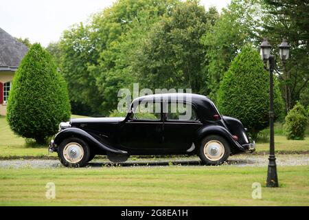 Oldtimer Citroen Traction 11 BL legere from 1957 in black, 4 cylinder inline engine, 1911 cm3, 125 km/h, in a park, Bretagne, France Stock Photo