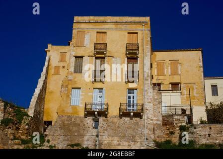 Facade of an old building on Chania's harbour promenade on the island of Crete, Greece Stock Photo