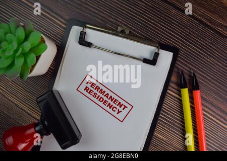 Red Handle Rubber Stamper and Permanent Residency text isolated on White Background. Stock Photo