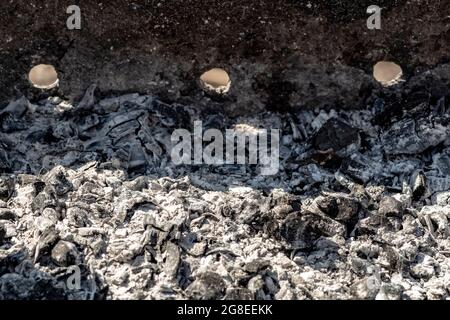 Black burnt coals in the grill close-up. Stock Photo