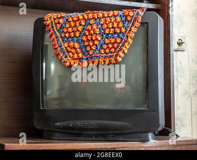 The old picture tube TV is covered with a cape. Stock Photo