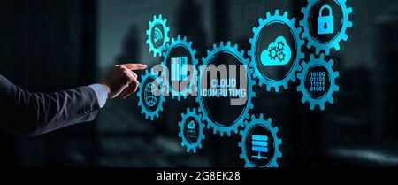 Cloud computing concept. Businessman is pressing on the virtual screen inscription Cloud computing. Stock Photo