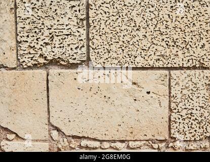 Background of the stone wall of the castle made of stones of different shapes and sizes and textures Stock Photo