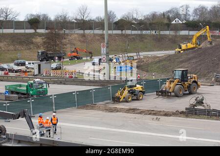 Hamburg, Germany. 19th Mar, 2021. Excavators demolish a bridge over the ...