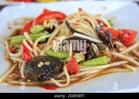 Papaya salad with salted crab, tomatoes and string beans, women like to eat it because it is a good diet that can control weight. Stock Photo