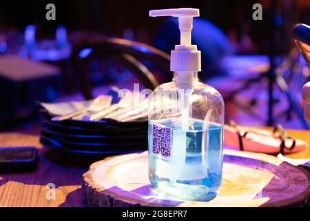 sanitizer bottle with QR code for digital menu being scanned on mobile ...