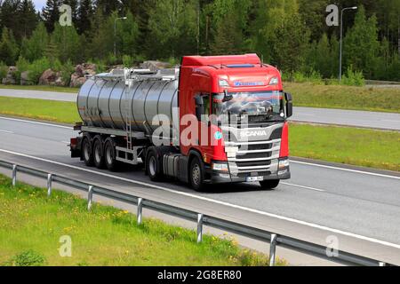 Red Scania R450 semi tanker truck Tomega at speed on motorway in Finland. Salo, Finland. May 28, 2021. Stock Photo