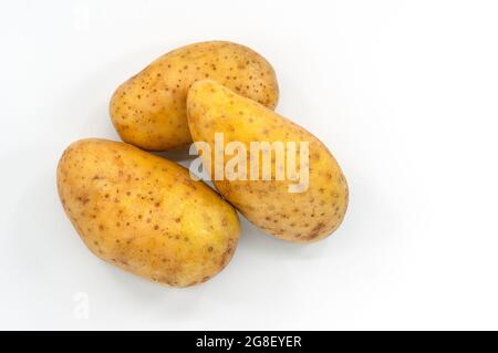 Top view small a group of fresh potato on white background, close up image three potatoes, soft shadow. Stock Photo