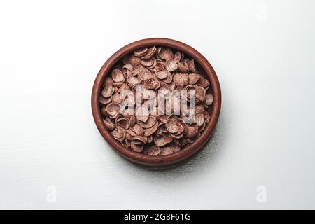 Wooden bowl with chocolate quick breakfast cereal on white backg Stock Photo
