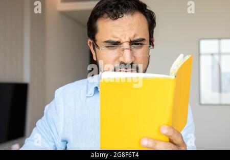 middle aged man with poor eyesight trying to read notes Stock Photo