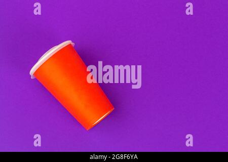 Takeaway cup of coffee on bright colored background Stock Photo