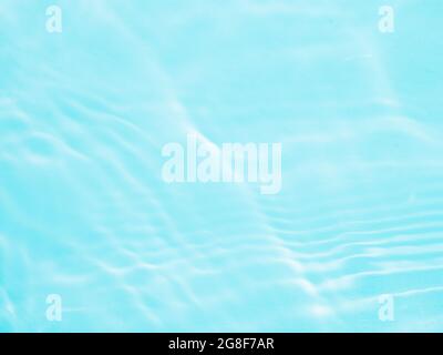 Ripple water texture on blue pool background. Shadow of water on sunlight. Mockup for product, spa or travel background. Marble blue water surface as wallpaper background Stock Photo