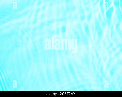 Ripple water texture on blue pool background. Shadow of water on sunlight. Mockup for product, spa or travel background. Marble blue water surface as wallpaper background Stock Photo