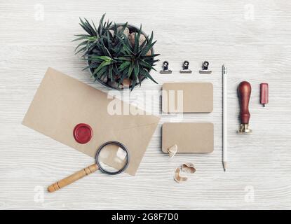 Blank retro stationery on light wood table background. Mockup for your design. Top view. Flat lay. Stock Photo