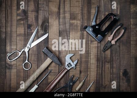 Used work tools on wooden background. Top view. Flat lay. Stock Photo