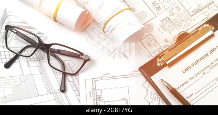 Architect sketching project on blueprint at site construction work, background photo Stock Photo