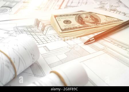 Working on construction project background. Office table with dollars and pen Stock Photo