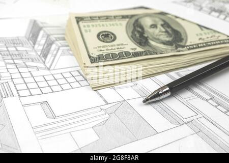 Working on construction project background. Office table with dollars and pen on sketches Stock Photo