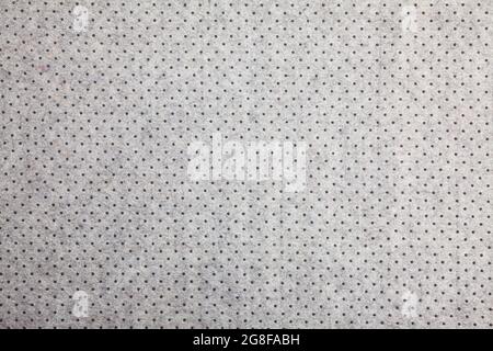 Grey felt material background with dark dots Stock Photo