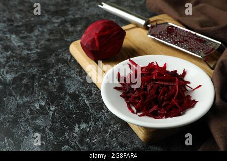 Fresh grated beets on black smokey table Stock Photo