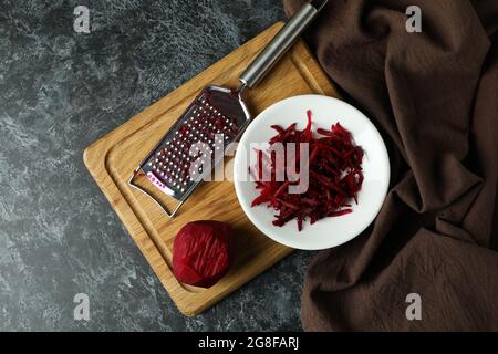 Fresh grated beets on black smokey table Stock Photo