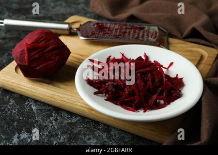 Fresh grated beets on black smokey table Stock Photo