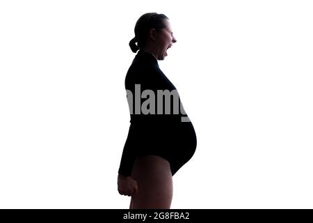 Screaming angry young pregnant woman. Silhouette view Stock Photo