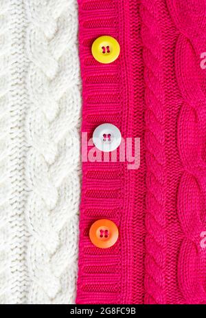 Knitted sweaters white and red and multi-colored buttons. Textures Stock Photo