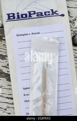 BioPack bag and a forensic cotton swab for securing blood and secretions, which is part of the police's forensic investigation at a crime scene. Stock Photo