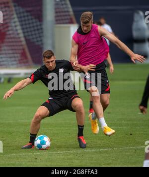 Leipzig, Germany. 20th July, 2021. Football: Bundesliga, Training RB Leipzig at the Red Bull Academy. Willi Orban (l) and Alexander Sörloth train on the pitch. Credit: Hendrik Schmidt/dpa-Zentralbild/dpa - IMPORTANT NOTE: In accordance with the regulations of the DFL Deutsche Fußball Liga and/or the DFB Deutscher Fußball-Bund, it is prohibited to use or have used photographs taken in the stadium and/or of the match in the form of sequence pictures and/or video-like photo series./dpa/Alamy Live News Stock Photo