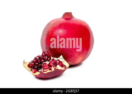 Juicy pieces of bright red cut pomegranate isolated on white background. Stock Photo