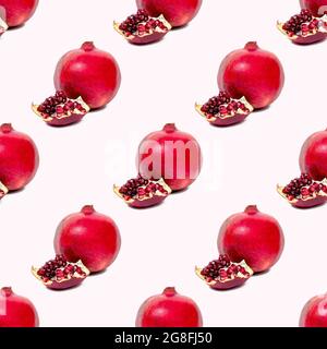 Bright red pomergranate pieces repeat seamless pattern on light pink background. Stock Photo