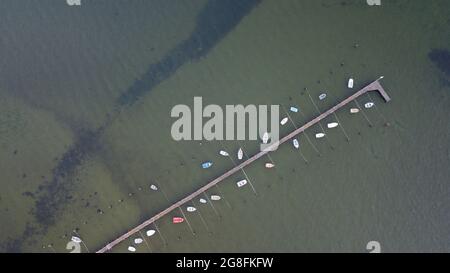 Aerial view of small boats moored on a pier in Poole harbour from directly above Stock Photo