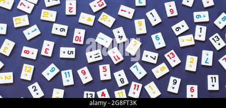 rummikub tiles isolated on black background, top view of game tiles, numbers background photo. Turkish board game rummikub (Turkish name is okey). Stock Photo