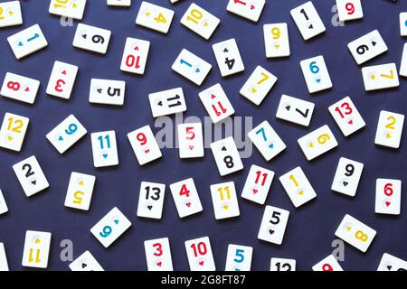 rummikub tiles isolated on black background, top view of game tiles, numbers background photo. Turkish board game rummikub (Turkish name is okey). Stock Photo