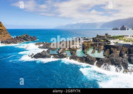 Natural pools formed by volcanic lava filled with crystal-clear sea water, Porto Moniz, Madeira island, Portugal, Atlantic, Europe Stock Photo