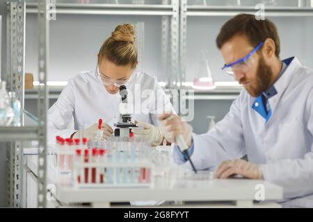 Health researchers diverse team working in biological science laboratory Stock Photo